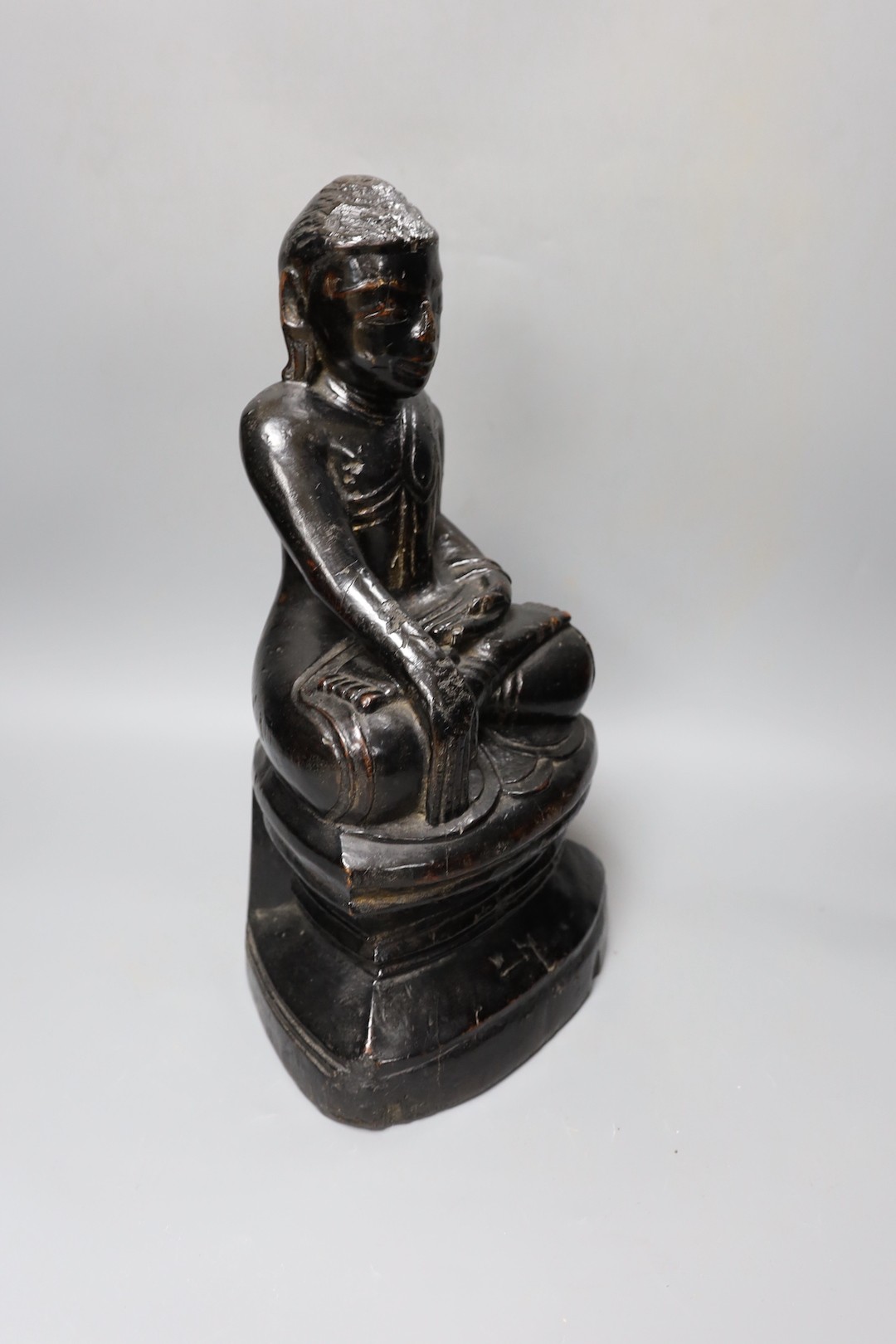 An 18th/19th century Burmese lacquered wood seated figure of Buddha Shakyamuni, 40cm